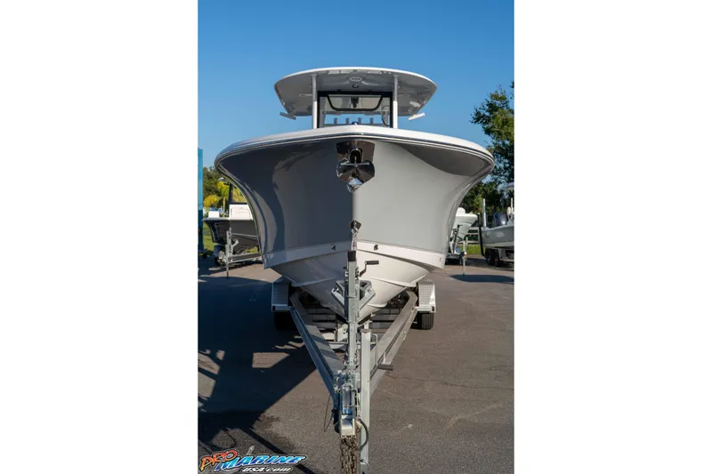 Slide: The Image of 2026 Sea Hunt Ultra 285 SE boat on trailer, front view, sunny day. - 16