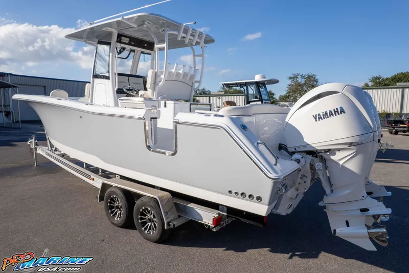 Slide: The Image of 2026 Sea Hunt Ultra 285 SE boat on trailer with Yamaha engines, parked outdoors. - 19