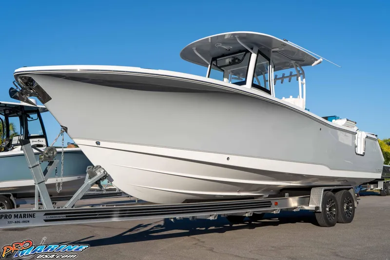 Slide: The Image of 2026 Sea Hunt Ultra 285 SE boat on trailer under clear blue sky. - 20