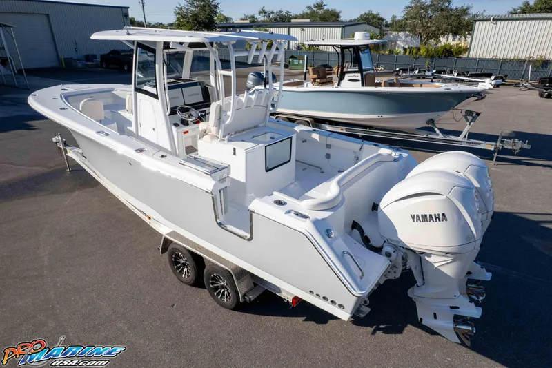 Slide: The Image of 2026 Sea Hunt Ultra 285 SE boat with dual Yamaha engines on a trailer. - 21