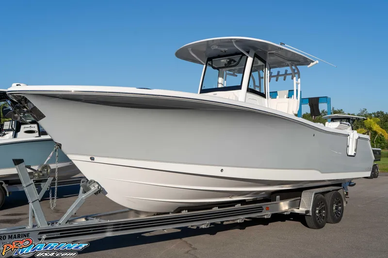 Slide: The Image of 2026 Sea Hunt Ultra 285 SE boat on trailer, displayed outdoors under clear blue sky. - 22