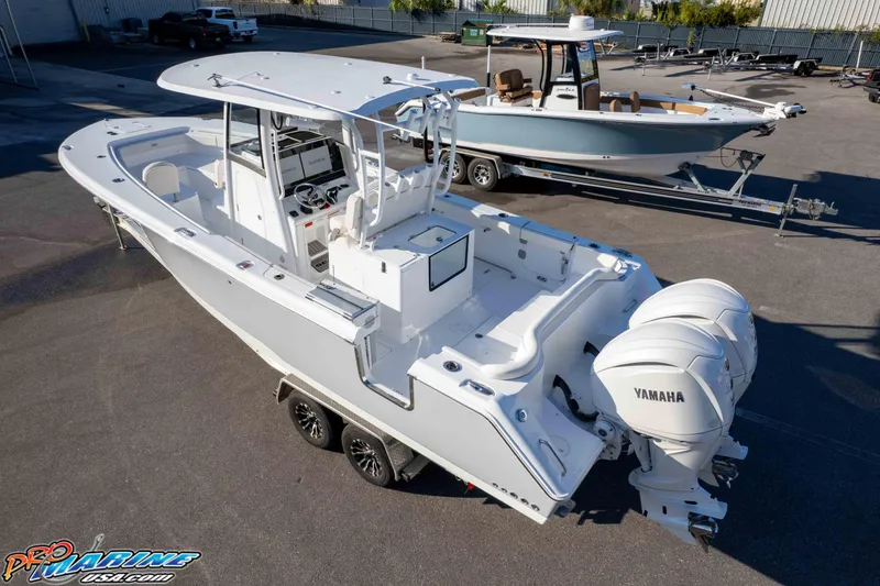Slide: The Image of 2026 Sea Hunt Ultra 285 SE boat with dual Yamaha engines in a parking lot. - 23