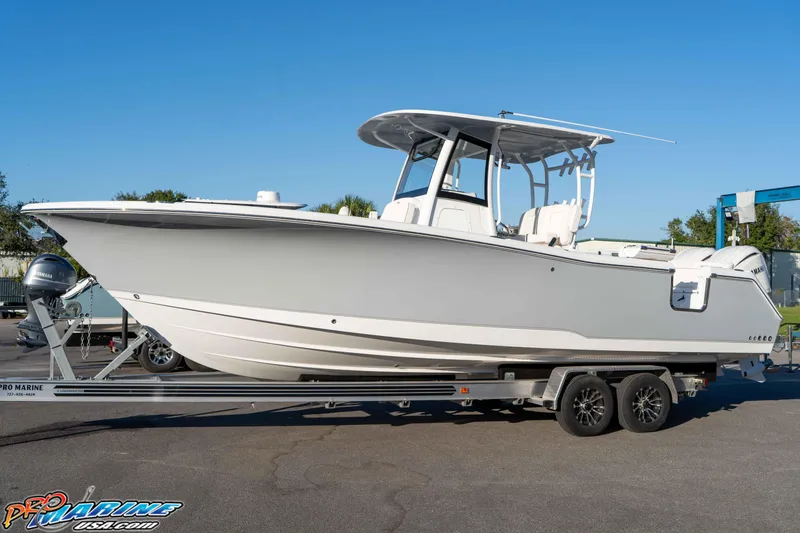 Slide: The Image of 2026 Sea Hunt Ultra 285 SE boat on trailer, side view, clear sky background. - 26