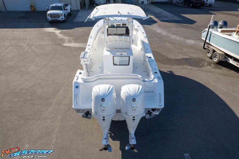 Slide: The Image of 2026 Sea Hunt Ultra 285 SE boat with dual engines, parked in a marina. - 29