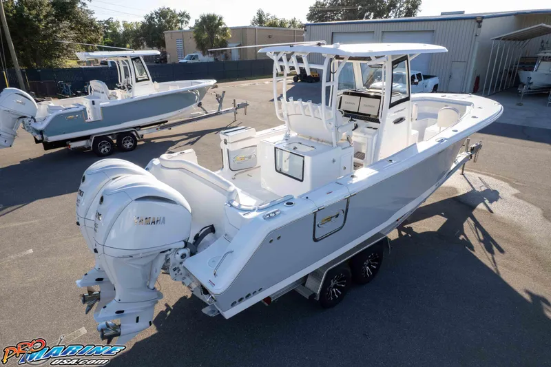 Slide: The Image of 2026 Sea Hunt Ultra 285 SE boat with dual Yamaha engines in a marina setting. - 33