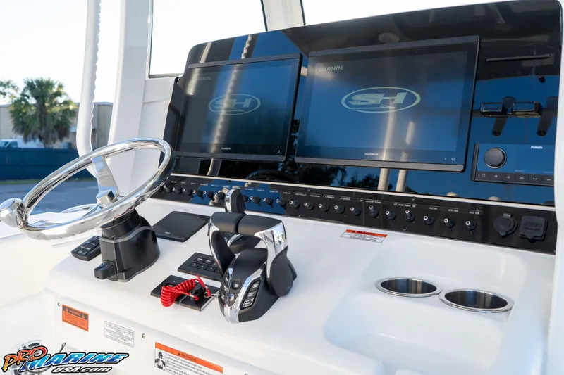 Slide: The Image of 2026 Sea Hunt Ultra 285 SE boat dashboard with dual Garmin displays and modern controls. - 49