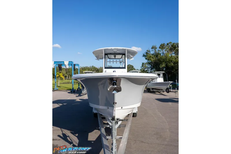 Slide: The Image of 2026 Sea Hunt Ultra 285 SE boat on trailer, parked outdoors under clear blue sky. - 5