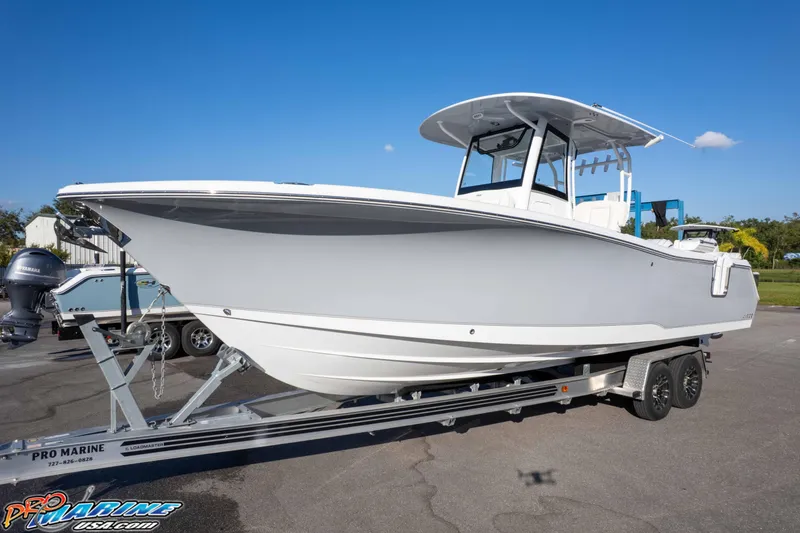 Slide: The Image of 2026 Sea Hunt Ultra 285 SE boat on trailer under clear blue sky. - 8