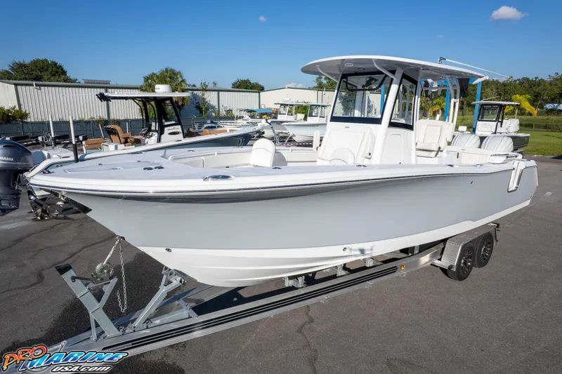 Slide: The Image of 2026 Sea Hunt Ultra 285 SE boat on trailer, displayed outdoors under clear sky. - 9