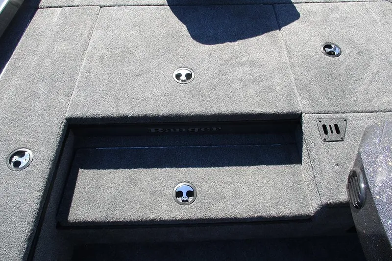 Slide: The Image of 2026 Ranger RT178 boat storage compartment with key lock and carpeted interior. - 15