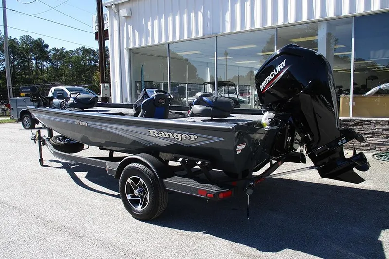 Slide: The Image of 2026 Ranger RT178 boat on trailer, parked outside a building. - 2