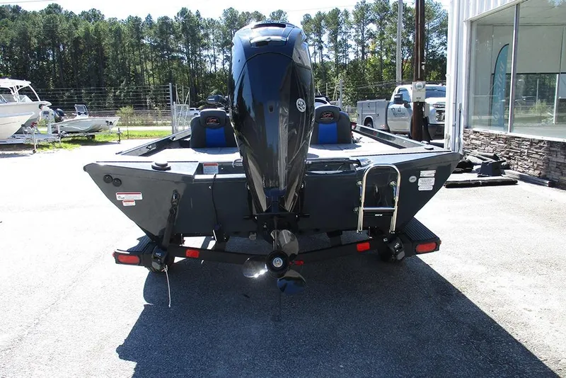 Slide: The Image of 2026 Ranger RT178 boat with Mercury engine, parked outdoors near storage facility. - 8