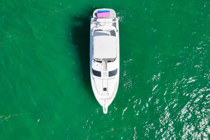 Slide: The Image of Aerial view of 2000 Sea Ray 450 Express Bridge yacht on vibrant green water. - 10