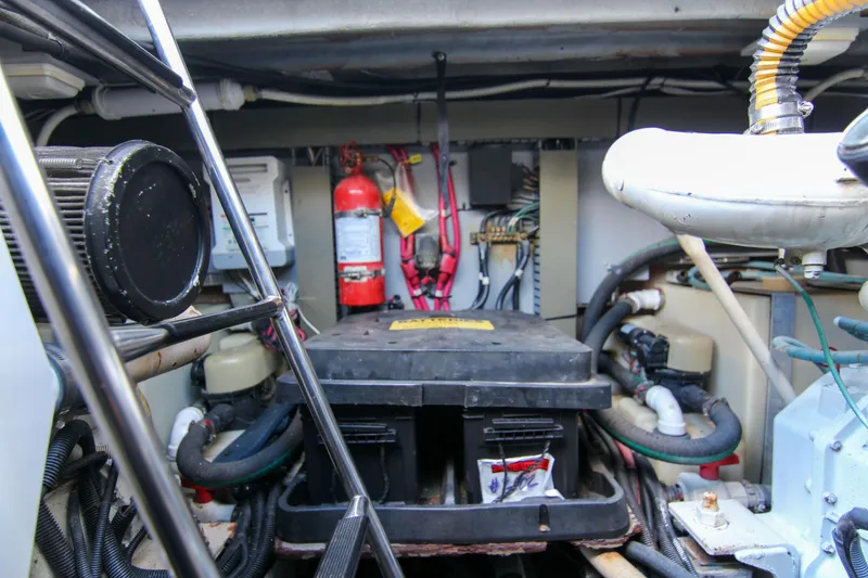 Slide: The Image of Engine room of 2000 Sea Ray 450 Express Bridge with fire extinguisher and equipment. - 13
