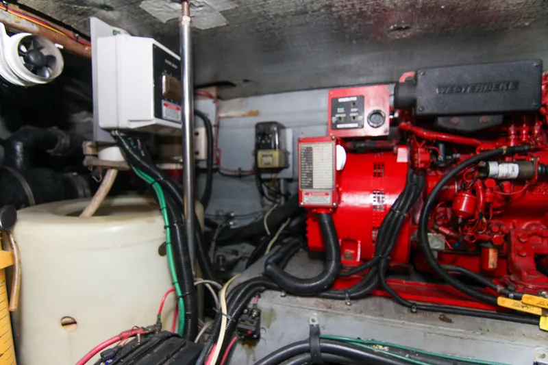 Slide: The Image of Engine room of 2000 Sea Ray 450 Express Bridge with red machinery and wiring. - 16