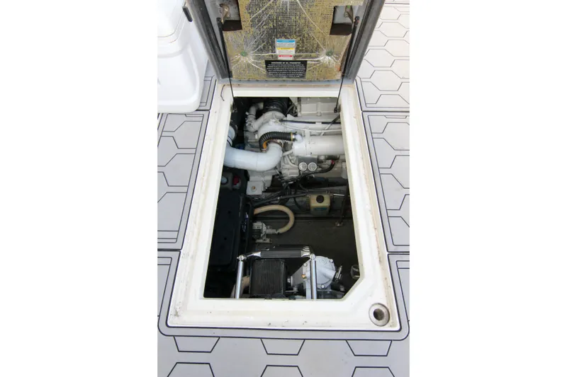 Slide: The Image of Engine compartment of 2000 Sea Ray 450 Express Bridge, showcasing mechanical components. - 18