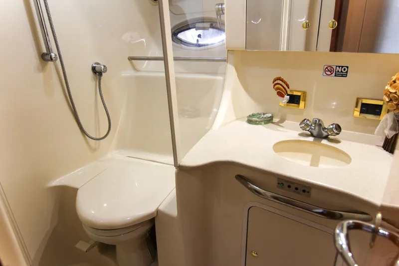 Slide: The Image of Bathroom interior of 2000 Sea Ray 450 Express Bridge yacht, featuring shower and sink. - 19