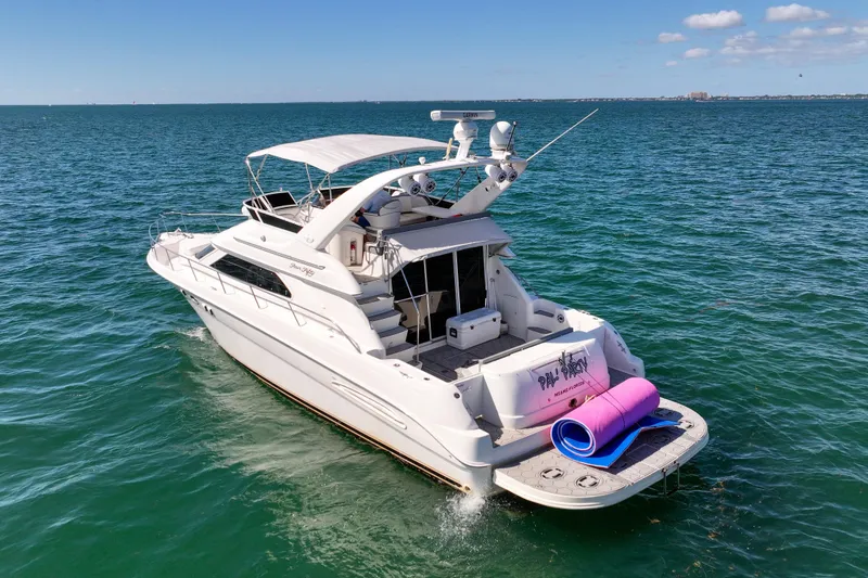 Slide: The Image of 2000 Sea Ray 450 Express Bridge cruising near city skyline on a sunny day. - 2