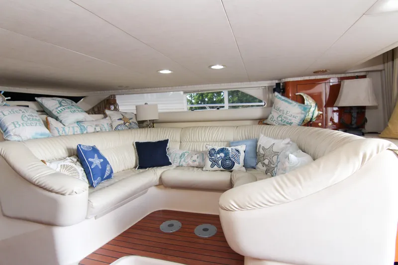Slide: The Image of Luxurious interior of 2000 Sea Ray 450 Express Bridge with plush seating and decorative pillows. - 32