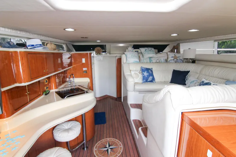 Slide: The Image of Luxurious interior of 2000 Sea Ray 450 Express Bridge with elegant seating and wood finishes. - 33