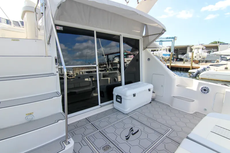 Slide: The Image of 2000 Sea Ray 450 Express Bridge yacht deck with stairs and seating area. - 36