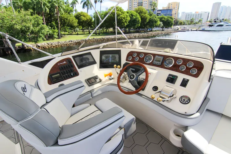 Slide: The Image of Helm of 2000 Sea Ray 450 Express Bridge yacht with modern controls and scenic waterfront view. - 37