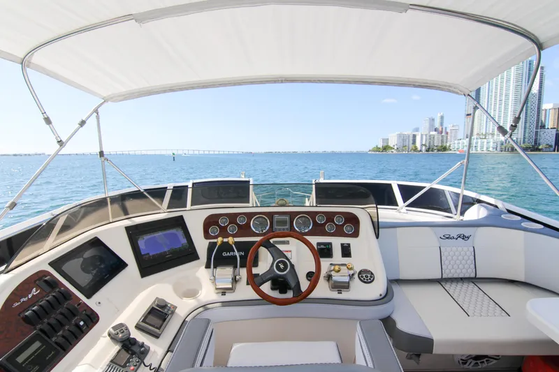 Slide: The Image of Cockpit view of 2000 Sea Ray 450 Express Bridge yacht with city skyline in background. - 41
