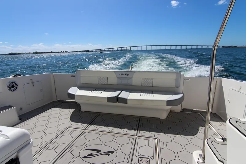 Slide: The Image of 2000 Sea Ray 450 Express Bridge cruising on open water, featuring spacious deck seating. - 48