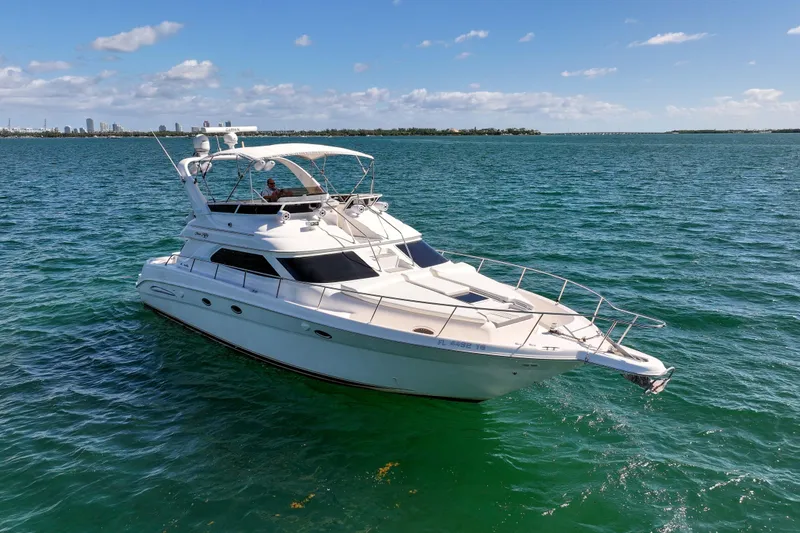 Slide: The Image of 2000 Sea Ray 450 Express Bridge yacht cruising on clear blue waters. - 5