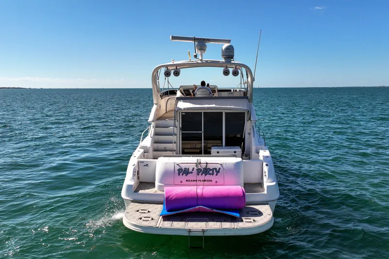 Slide: The Image of 2000 Sea Ray 450 Express Bridge yacht on open water, rear view. - 8