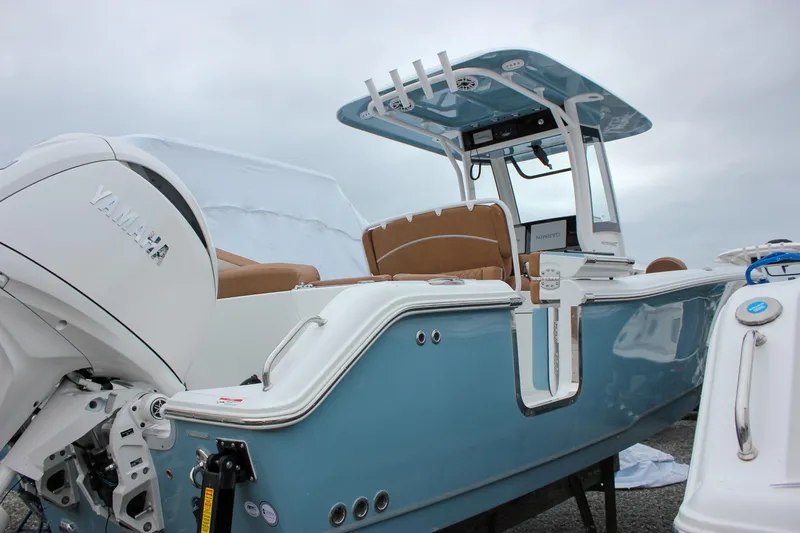 Slide: The Image of 2026 Sea Hunt Ultra 265 SE boat interior with tan seating and blue accents. - 10