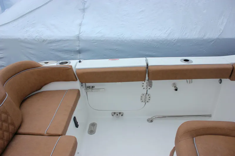 Slide: The Image of 2026 Sea Hunt Ultra 265 SE boat interior with tan seating and Yamaha engine. - 17