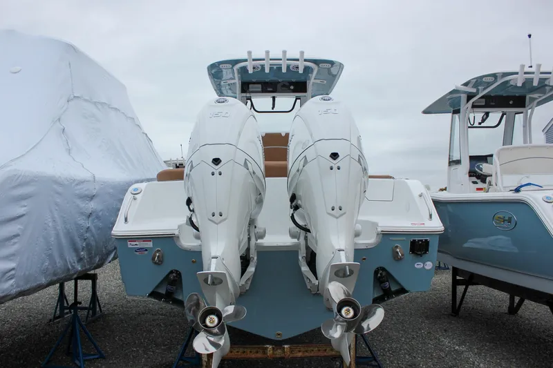 Slide: The Image of 2026 Sea Hunt Ultra 265 SE boat displayed outdoors, surrounded by other boats. - 2