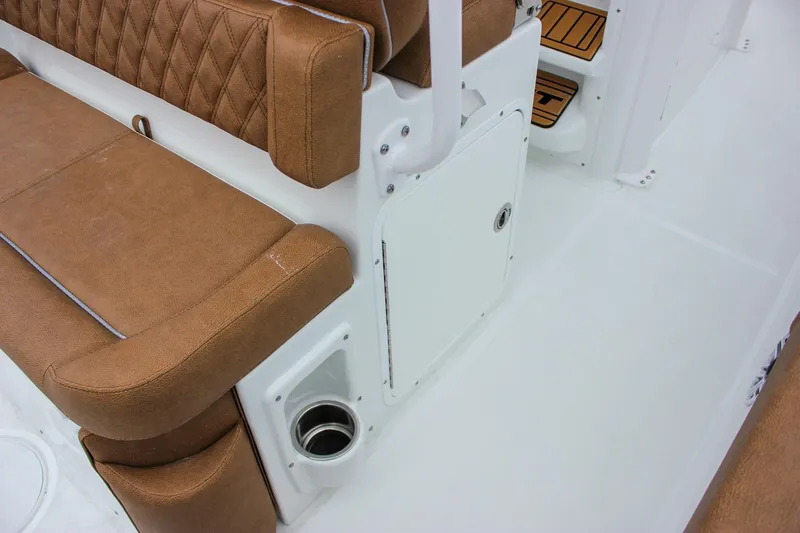 Slide: The Image of 2026 Sea Hunt Ultra 265 SE boat seating with tan upholstery and foldable armrests. - 22