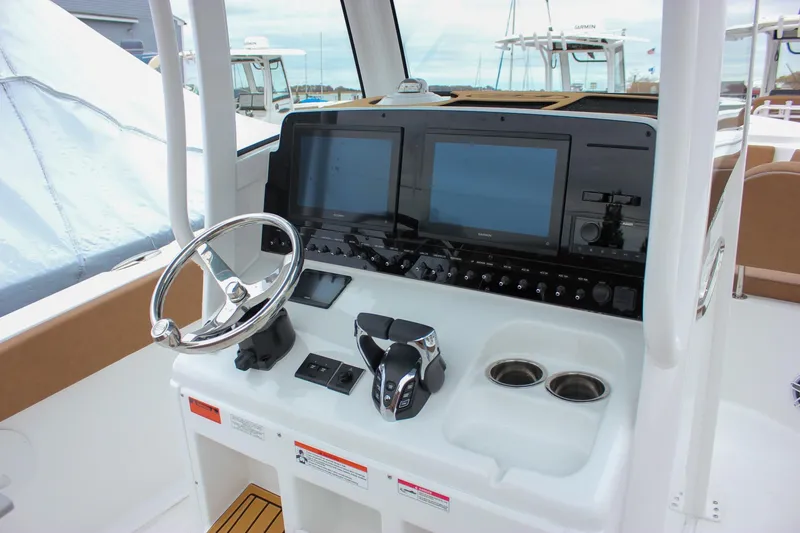 Slide: The Image of 2026 Sea Hunt Ultra 265 SE boat interior with tan seating and storage compartment. - 25