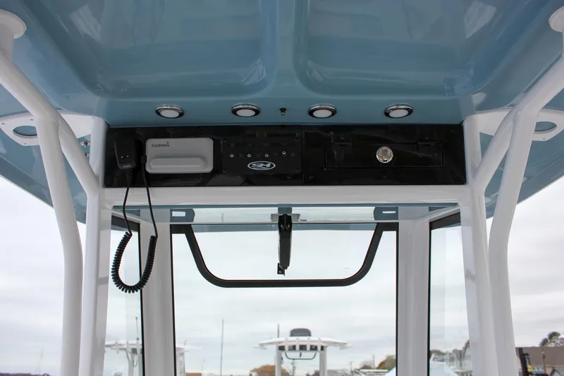 Slide: The Image of 2026 Sea Hunt Ultra 265 SE boat console with steering wheel and controls. - 31