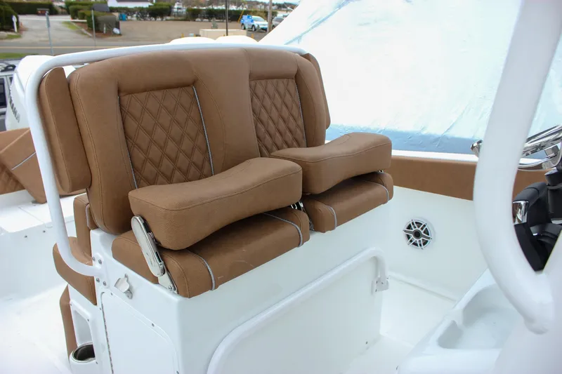 Slide: The Image of 2026 Sea Hunt Ultra 265 SE boat console with Garmin electronics and overhead storage. - 32