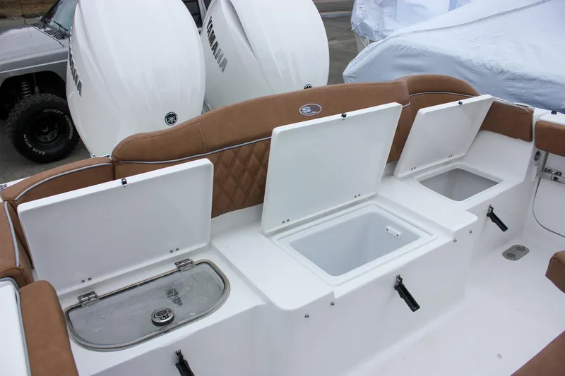 Slide: The Image of 2026 Sea Hunt Ultra 265 SE boat with tan seating and dual outboard motors. - 35