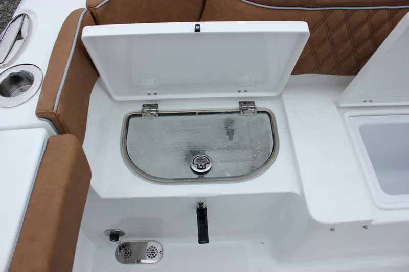 Slide: The Image of 2026 Sea Hunt Ultra 265 SE boat with open storage compartments and Yamaha engines. - 36