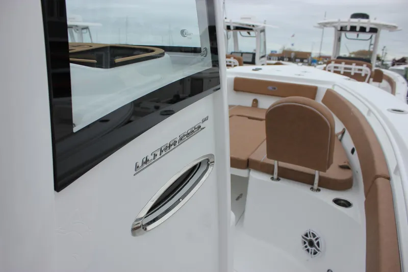 Slide: The Image of 2026 Sea Hunt Ultra 265 SE boat interior with storage compartments and cushioned seating. - 39