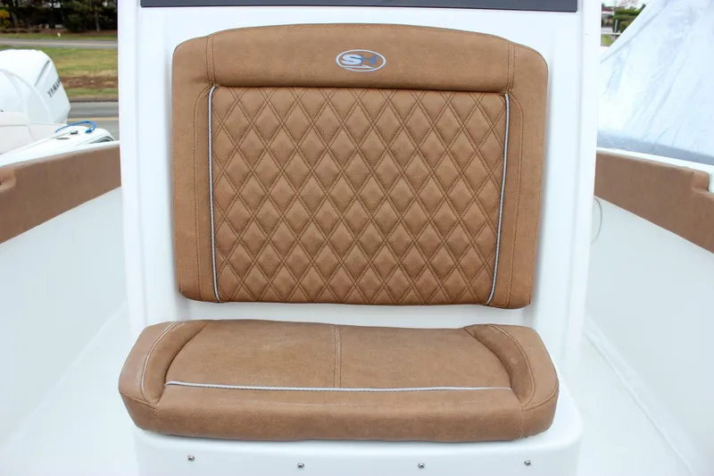 Slide: The Image of 2026 Sea Hunt Ultra 265 SE boat with tan seating at a marina. - 41