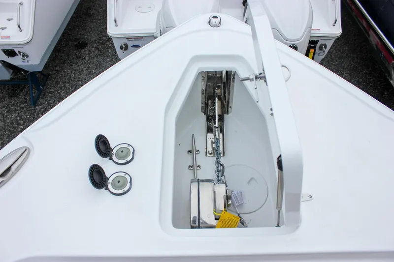 Slide: The Image of 2026 Sea Hunt Ultra 265 SE boat interior, featuring sleek white design and brown seating. - 47