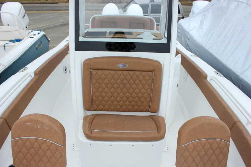 Slide: The Image of Hand opening USB port cover on 2026 Sea Hunt Ultra 265 SE boat. - 50