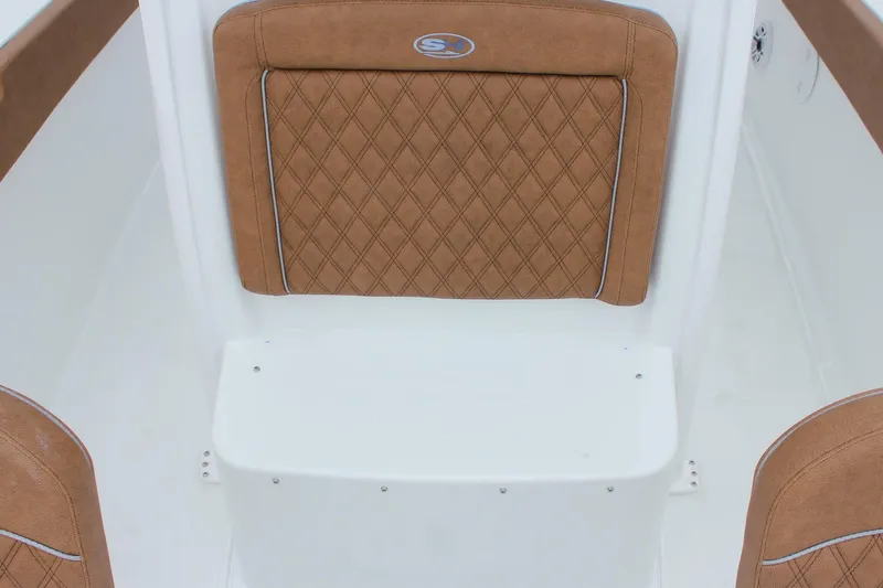 Slide: The Image of 2026 Sea Hunt Ultra 265 SE boat interior with tan diamond-stitched seating. - 51