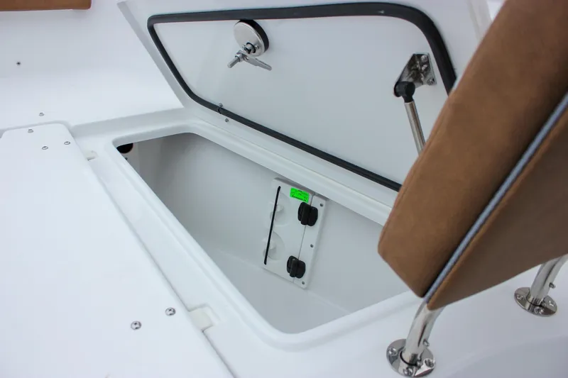 Slide: The Image of 2026 Sea Hunt Ultra 265 SE boat interior with brown diamond-stitched seating. - 52