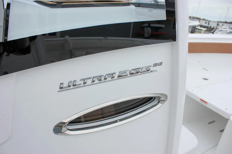 Slide: The Image of 2026 Sea Hunt Ultra 265 SE boat interior detail, featuring storage compartment and sleek design. - 57