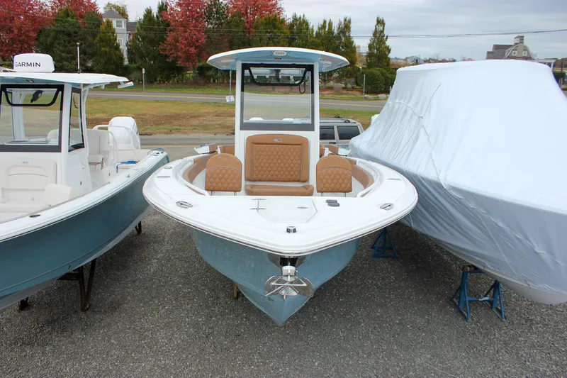 Slide: The Image of 2026 Sea Hunt Ultra 265 SE boat with triple engines at a marina. - 60
