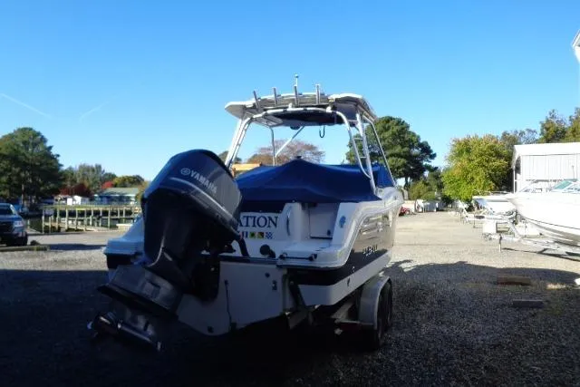 Slide: The Image of 2015 Robalo R247 Dual Console boat with Yamaha engine, parked outdoors on a sunny day. - 11