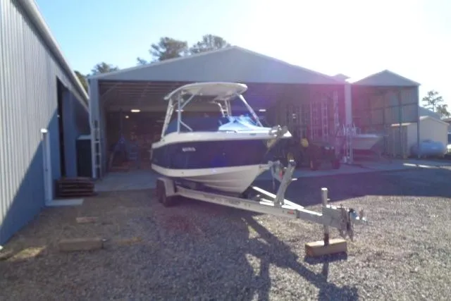 Slide: The Image of 2015 Robalo R247 Dual Console boat on trailer outside storage facility. - 14