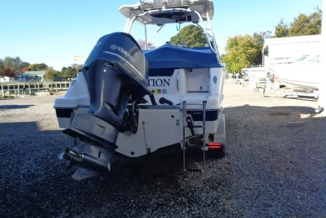 Slide: The Image of 2015 Robalo R247 Dual Console boat with Yamaha outboard motor, parked on gravel. - 15